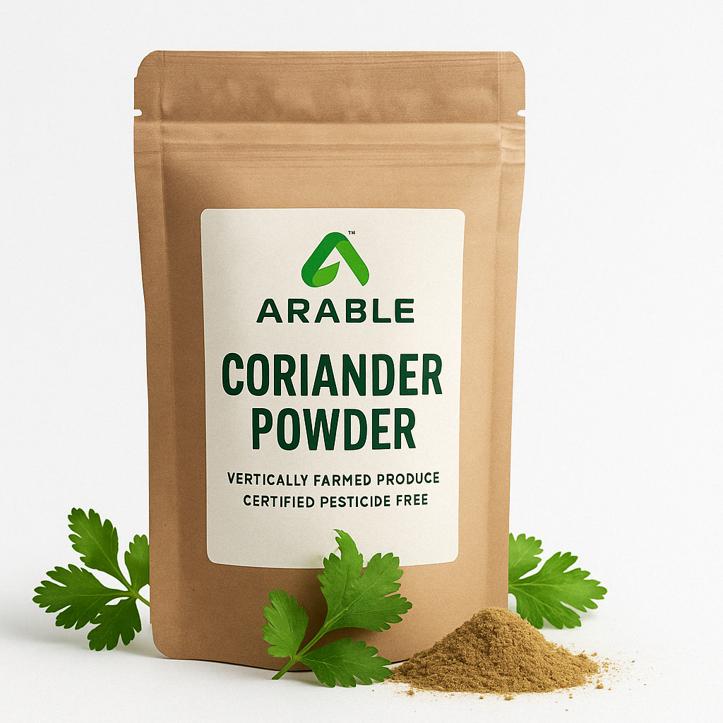 Arable Coriander Powder pouch with fresh coriander leaves and fine brown powder, labeled vertically farmed and certified pesticide-free