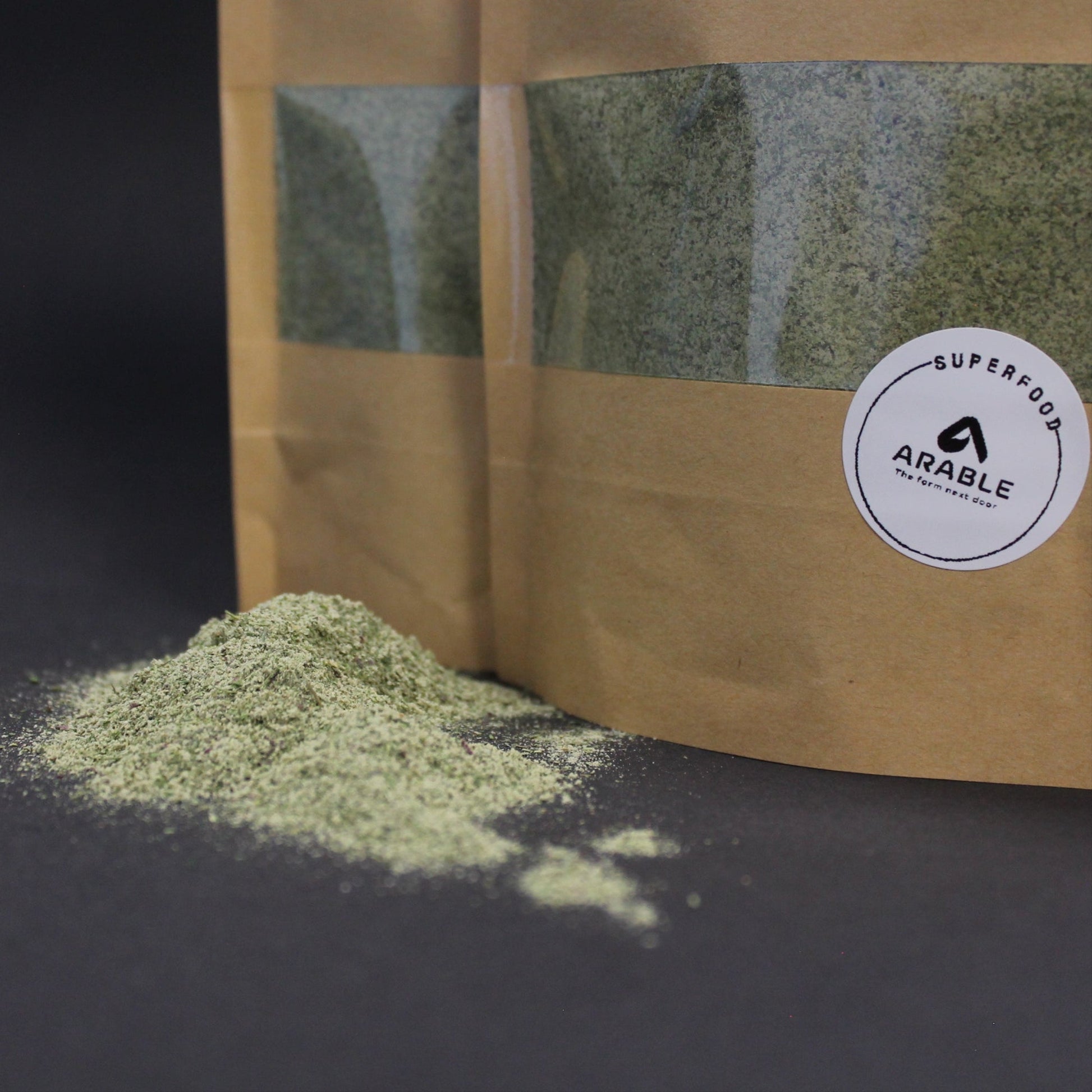 Organic microgreen powder blend in eco-friendly kraft packaging by Arable Grow, rich in antioxidants, vitamins, and chlorophyll. Superfood supplement for smoothies, shakes, and immune support.